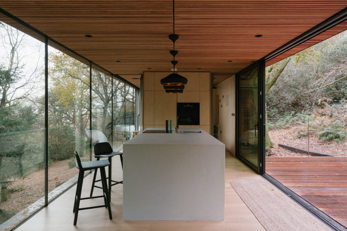 A Modern Woodland Lodge with A Scandi Interior 7 kitchen-island-sliding-doors-terrace-wood-lodge-nordroom