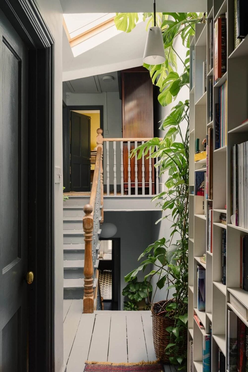 A Victorian House in London with Yellow Color Accents 23 landing-wooden-floor-bookshelves-stairs-plants-skylight-nordroom
