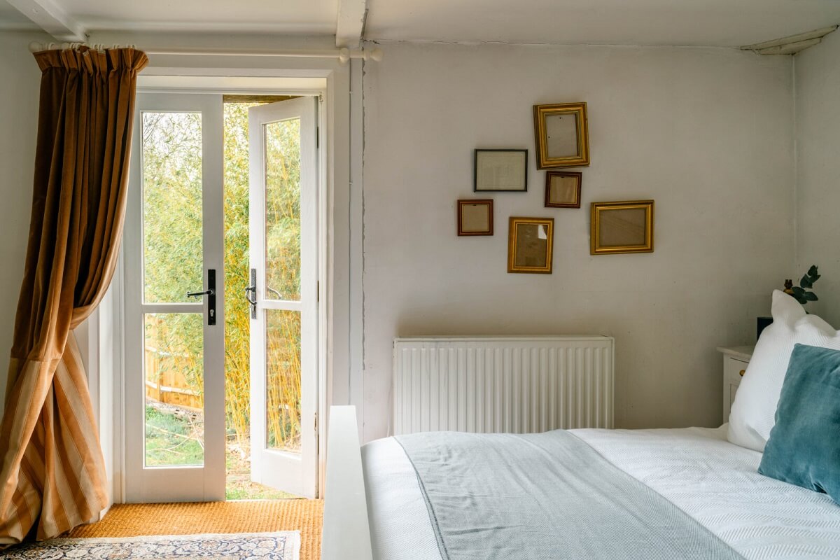 An English Barn Conversion Decorated in Green and Blue 16 light-bedroom-ochre-yellow-curtains-nordroom