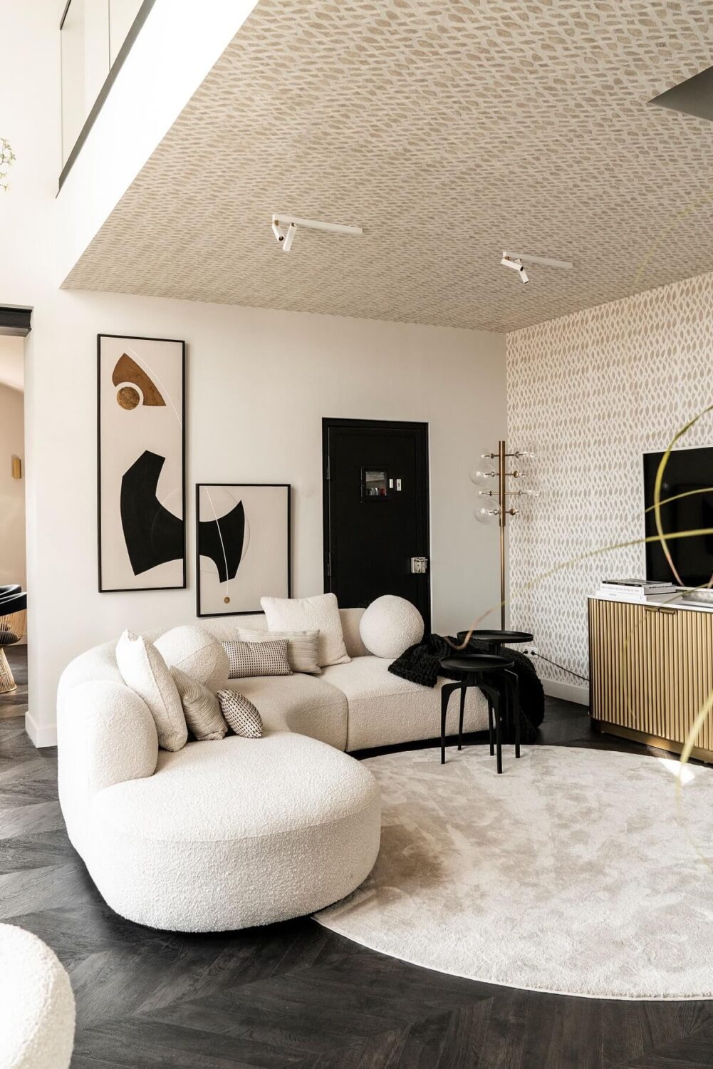 A Stylish Monochrome Penthouse in a Former Prison Building 2 loft-living-space-curved-sofa-round-rug-chevron-floor-nordroom