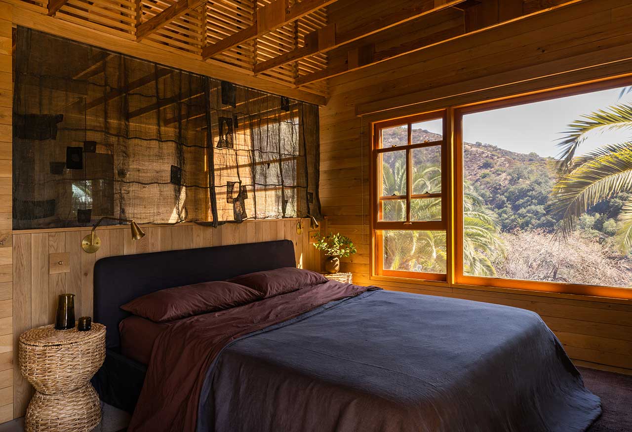The Warm Mountaintop Home of Actor Hayden Christensen 12 master-bedroom-moody-bedding-ensuite-bathroom-nordroom