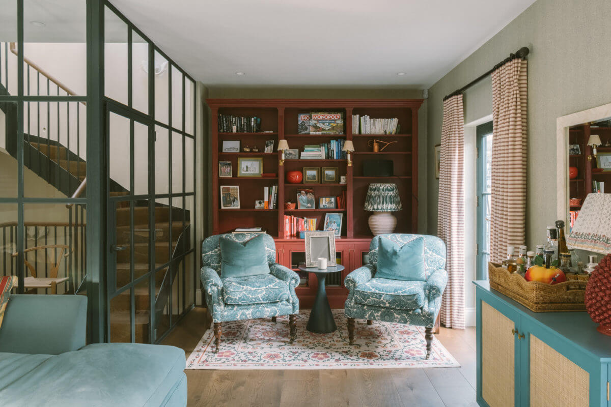 50+ Rooms That Prove ‘The Unexpected Red Theory’ Really Works 46 sitting-room-red-bookcase-steel-glass-door-wall-notting-hill-mews-house-nordroom