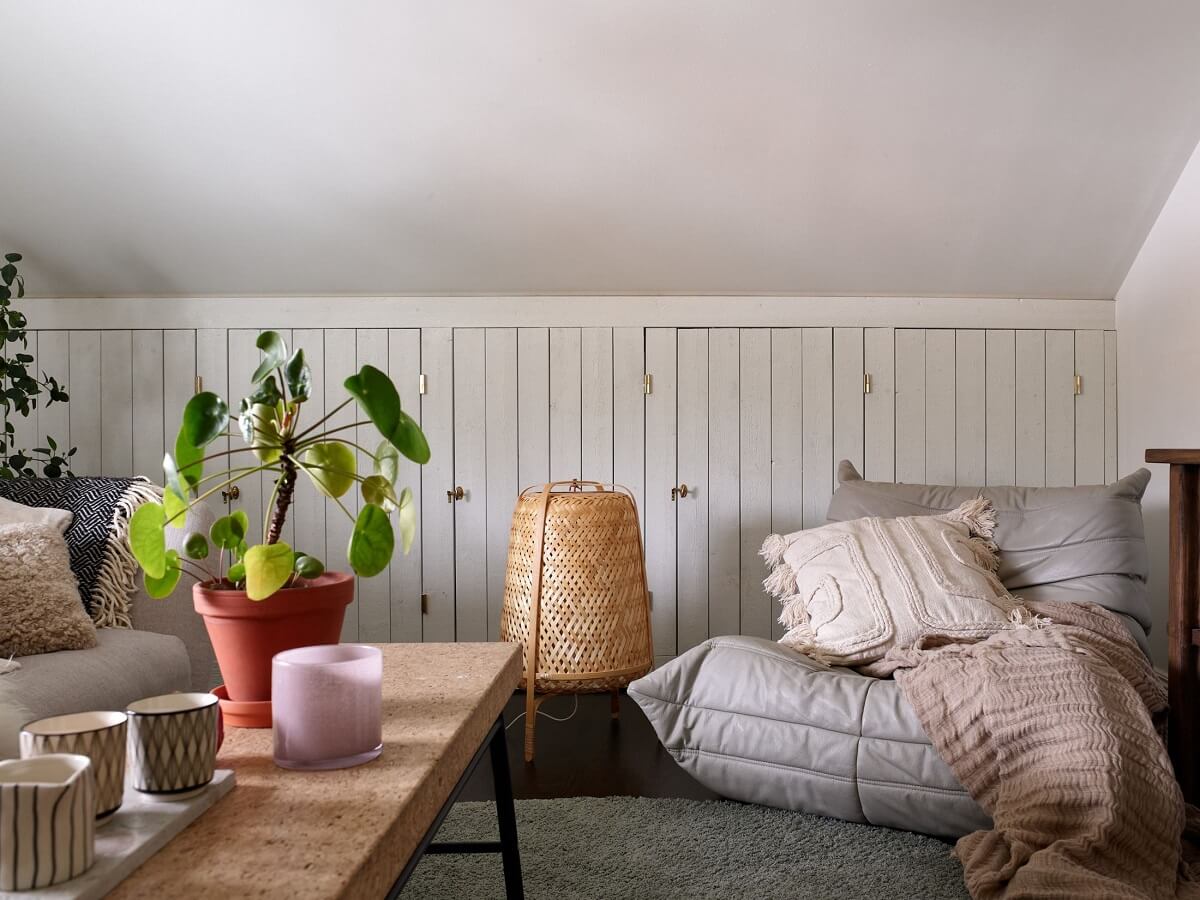 A Swedish Maisonette with a Charming Kitchen 14 sitting-room-slanted-ceiling-built-in-closets-togo-chair-nordroom