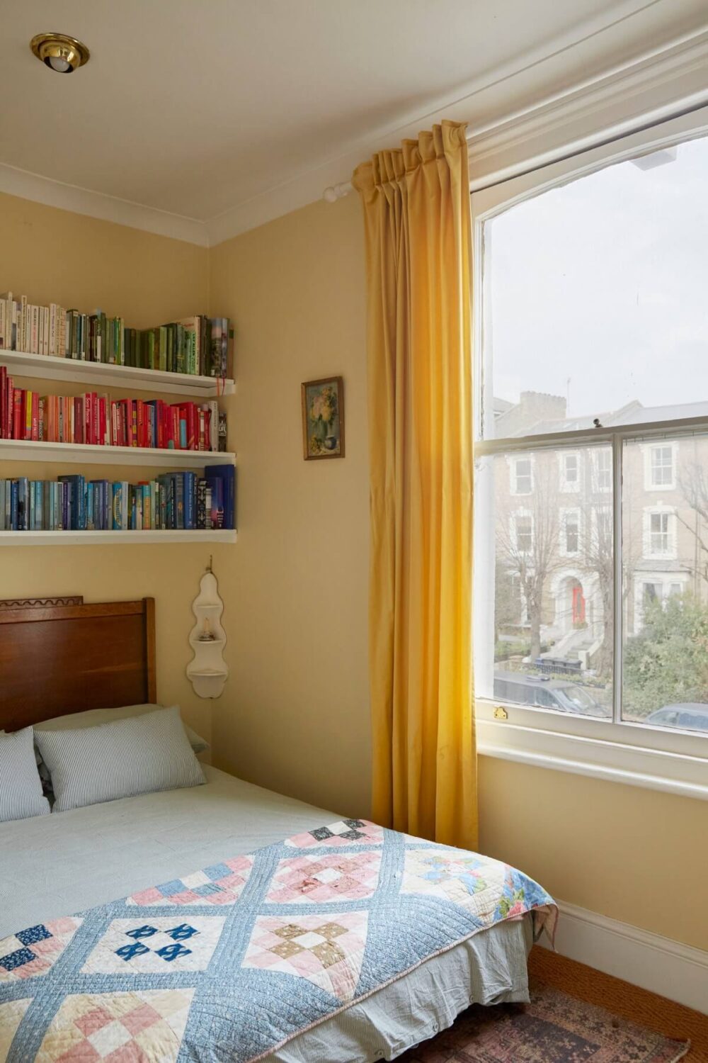 Glidden & PPG Color of the Year 2024: Limitless 17 small-bedroom-pastel-yellow-walls-shelves-nordroom