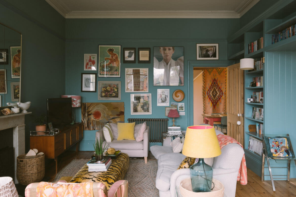 A Colorful Vintage Eclectic Home in England 5 vintage-eclectic-living-room-gallery-wall-bookshelves-blue-walls-nordroom