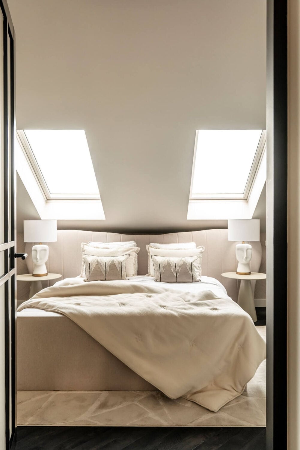 A Stylish Monochrome Penthouse in a Former Prison Building 18 white-bedroom-slanted-ceiling-skylights-nordroom