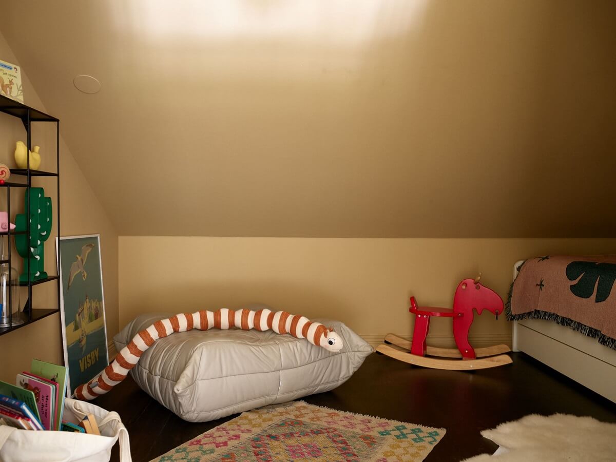 A Swedish Maisonette with a Charming Kitchen 17 yellow-kids-bedroom-slanted-ceiling-skylight-nordroom