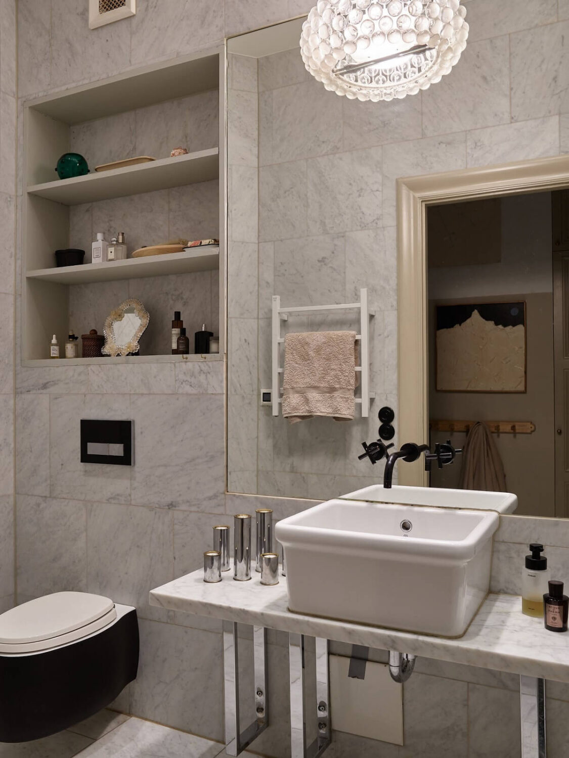 A Beige Vintage Apartment in Stockholm 17 bathroom-black-toilet-storage-shelves-nordroom