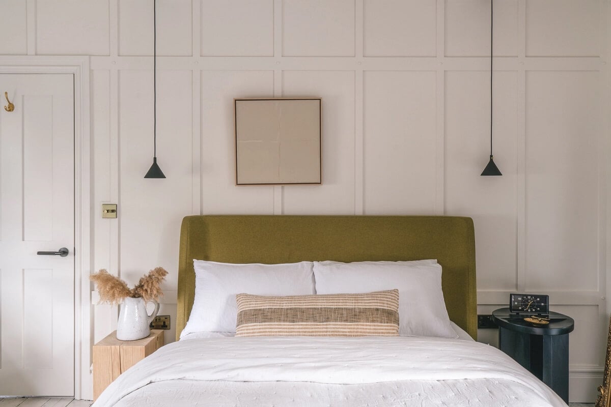 A Victorian Home with a Modern Black Extension 16 bedroom-green-headboard-whte-walls-nordroom