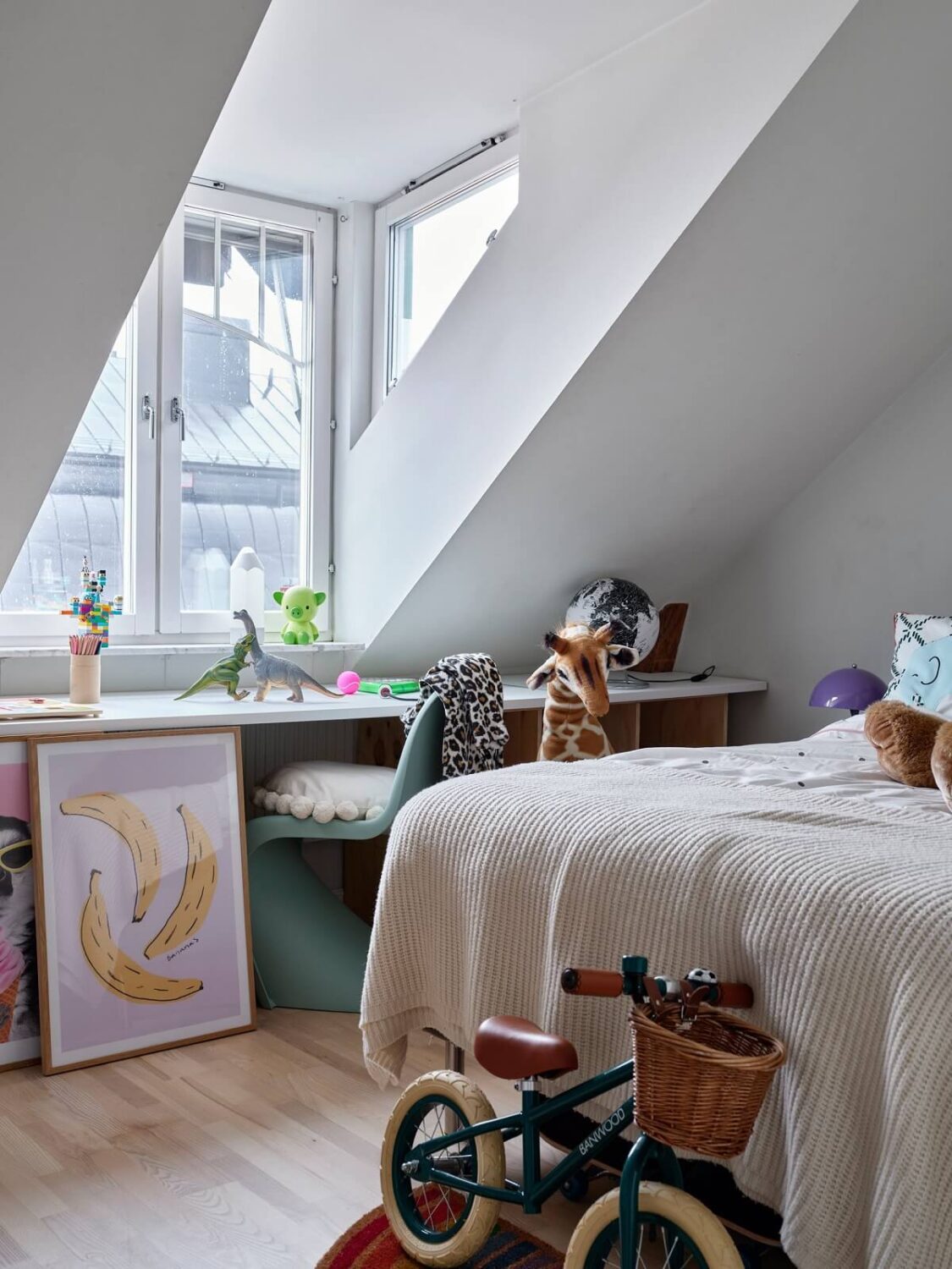 Pastel Color Accents in a Scandinavian Penthouse Apartment 16 bedroom-slanted-ceiling-desk-under-window-nordroom