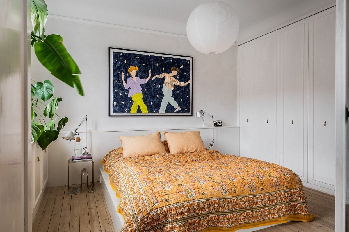An Oslo Apartment with Custom Made Storage Solutions 8 bedroom-wooden-floor-yellow-bedding-built-in-wardrobes-nordroom