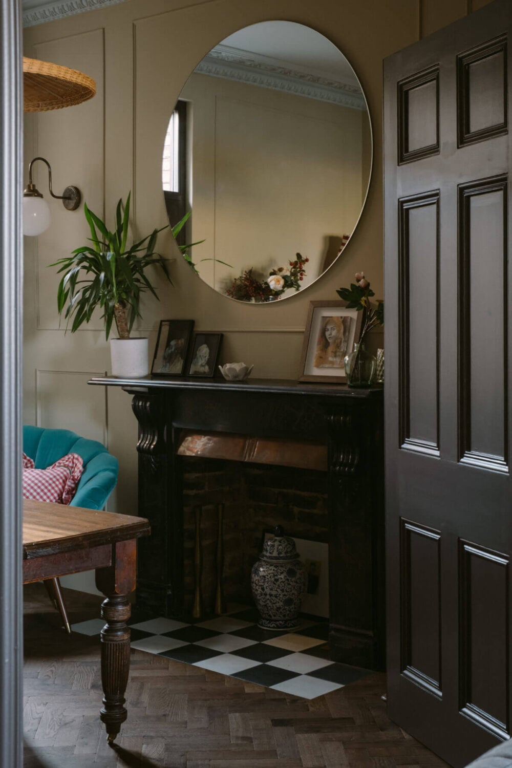A Deep Red Kitchen in a Victorian Home in London 5 black-fireplace-checkerboard-tiles-round-mirror-nordroom