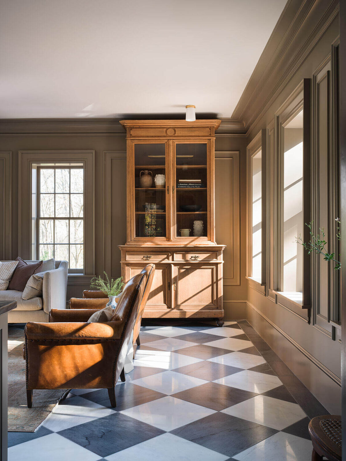 A Classic 1930s Home in Grand Rapids Designed by Jean Stoffer 6 black-white-checkerboard-floor-living-room-leather-club-chairs-nordroom