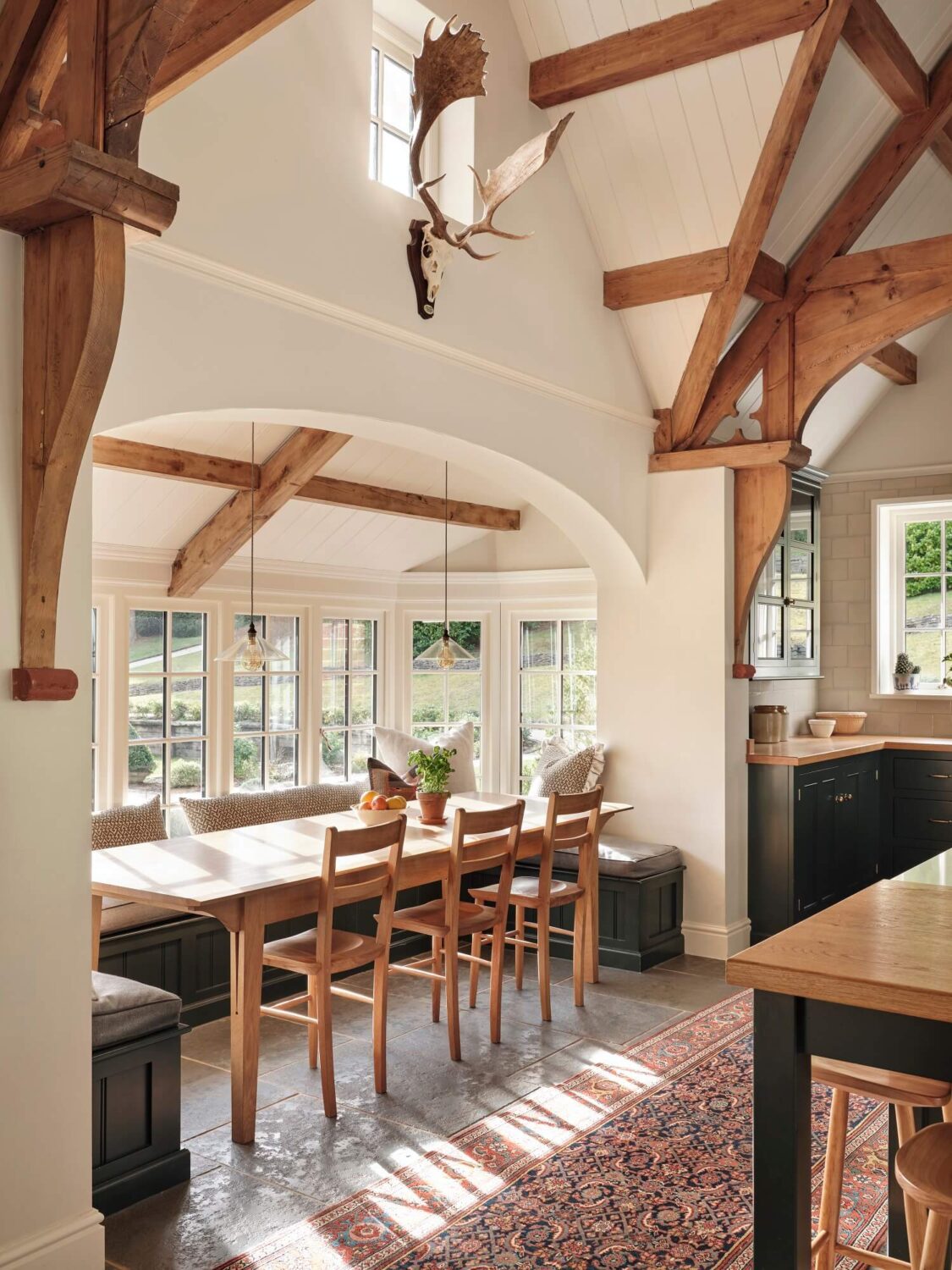 A Grand Family Kitchen in an English Country House 3 breakfast-nook-built-in-bench-exposed-wooden-beams-kilim-runner-large-kitchen-nordroom