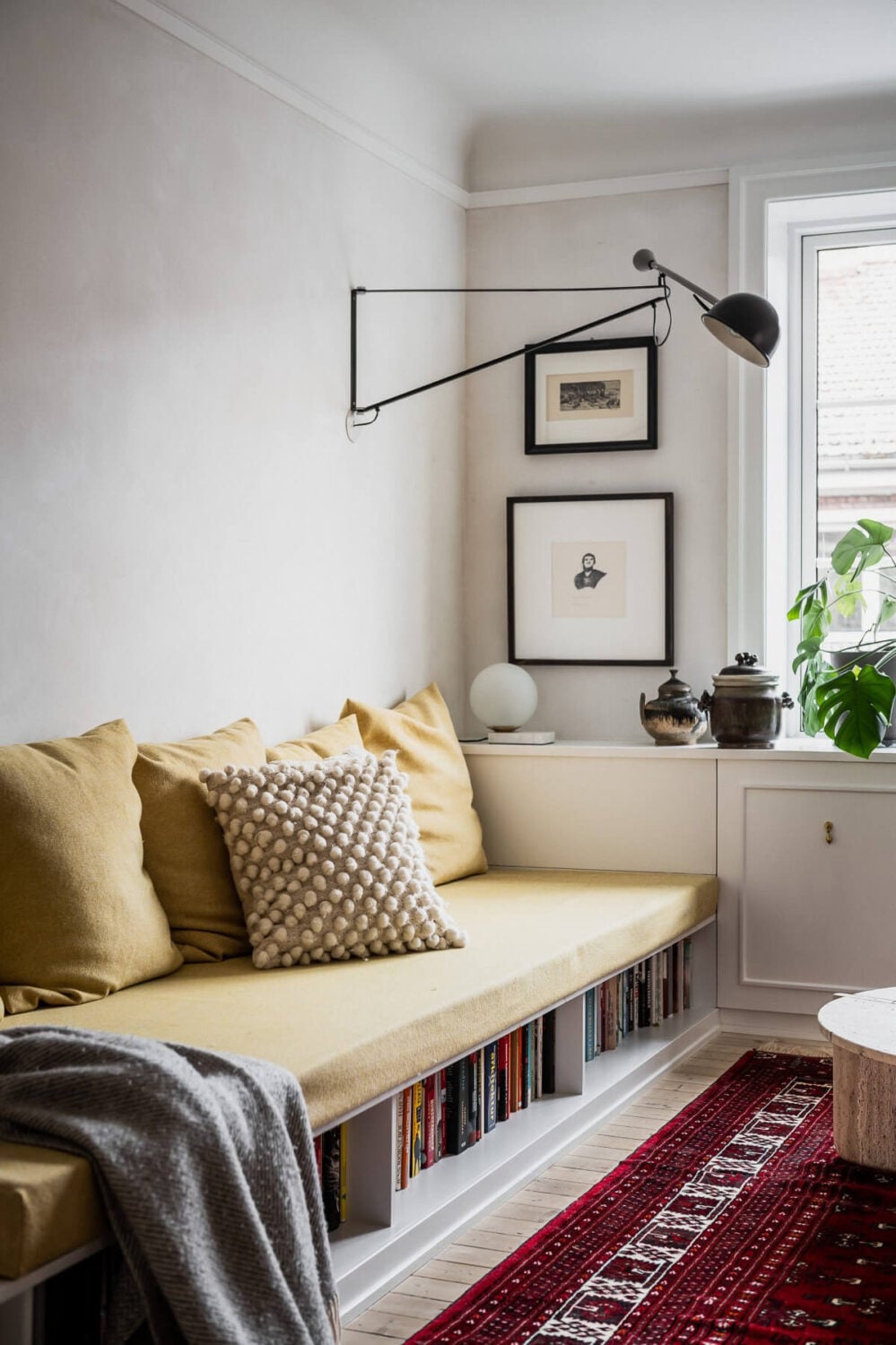 An Oslo Apartment with Custom Made Storage Solutions 3 custom-sofa-underneath-storage-yellow-cushions-nordroom