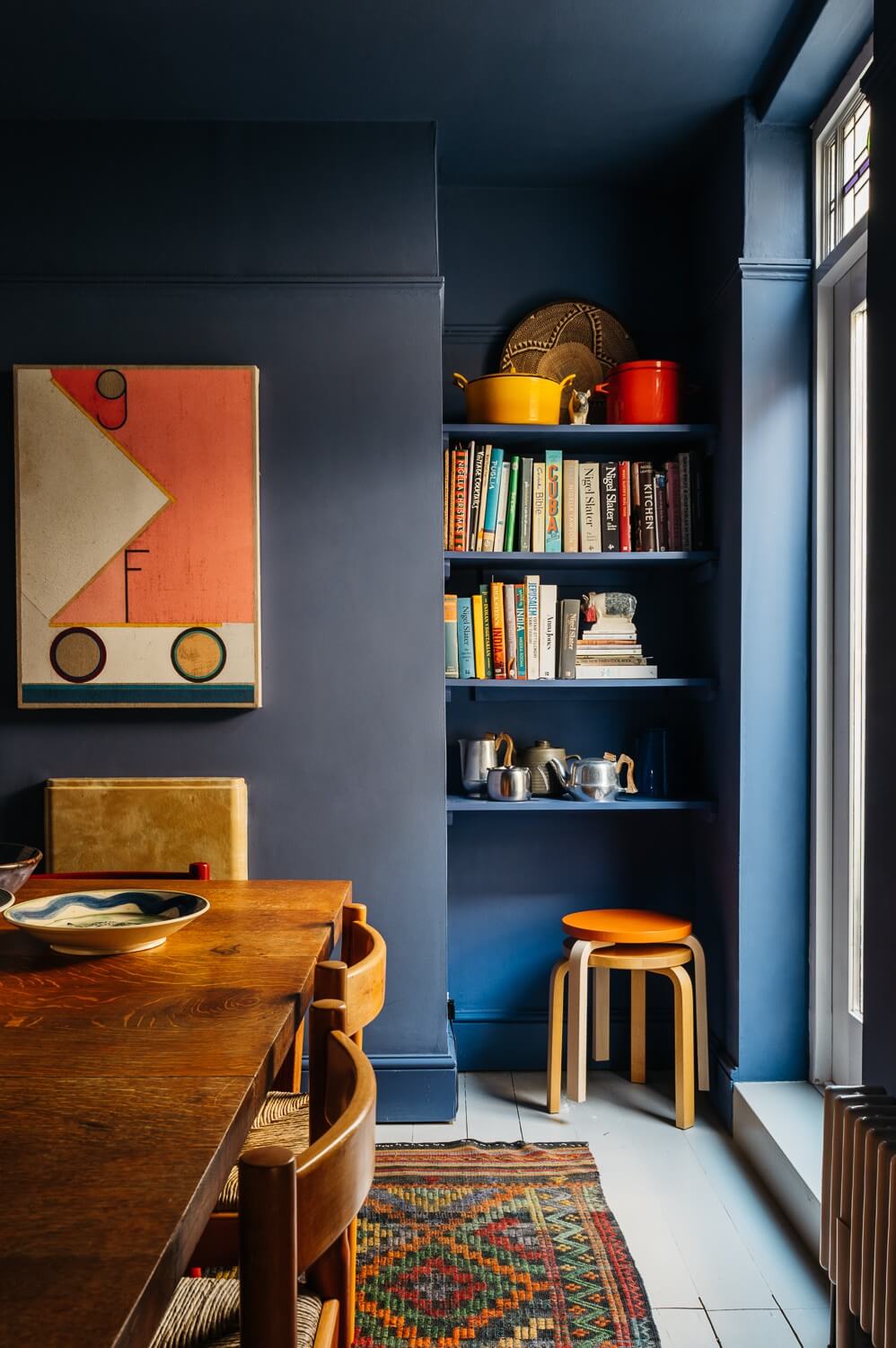 Colorful Rooms in a Historic English Home 8 dining-room-dark-blue-walls-built-in-bookshelves-nordroom
