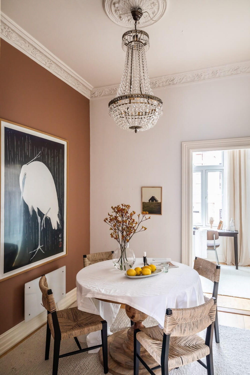 An Oslo Apartment Painted in Warm Color Tones 10 dining-room-round-mirror-chandelier-brown-earthy-wall-color-nordroom