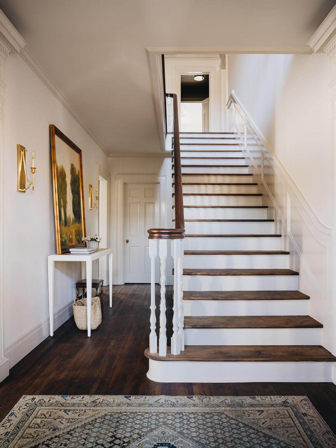 A Classic 1930s Home in Grand Rapids Designed by Jean Stoffer 24 foyer-hallway-dark-wooden-floor-stairs-jean-stoffer-nordroom