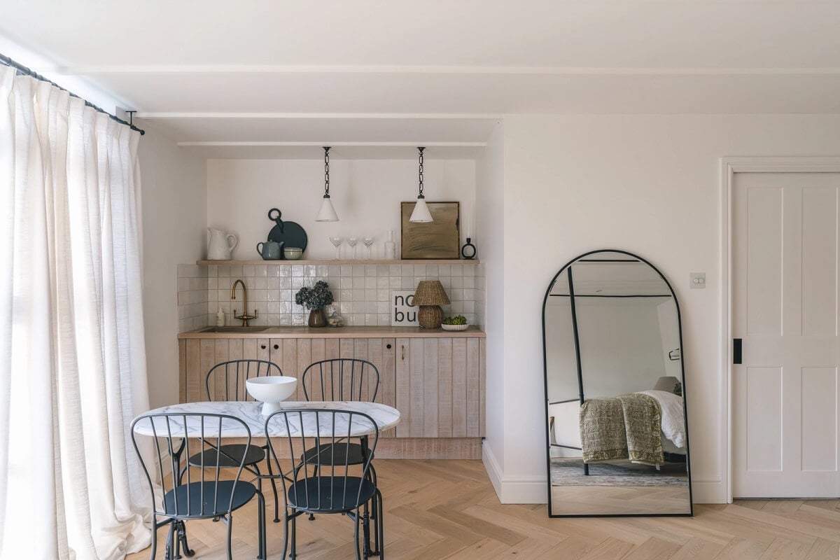 A Victorian Home with a Modern Black Extension 29 guest-house-small-kitchen-arched-mirror-nordroom