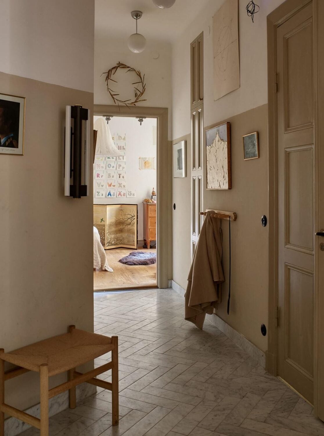 A Beige Vintage Apartment in Stockholm 12 hallway-beige-walls-herringbone-floor-nordroom