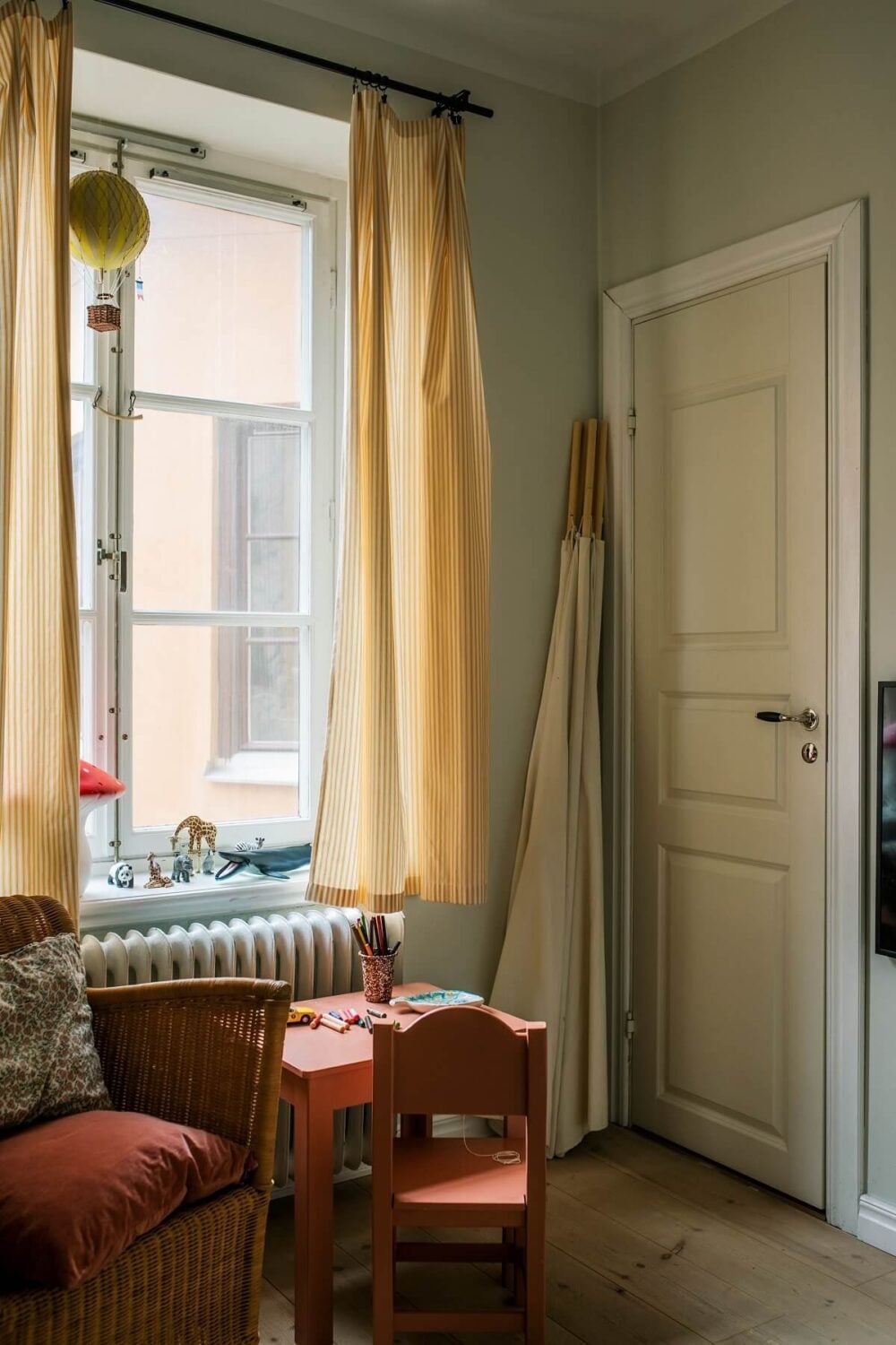 A Serene Light Colored Apartment in Stockholm 14 kids-bedroom-wooden-floor-yellow-curtains-scandinavian-home-nordroom