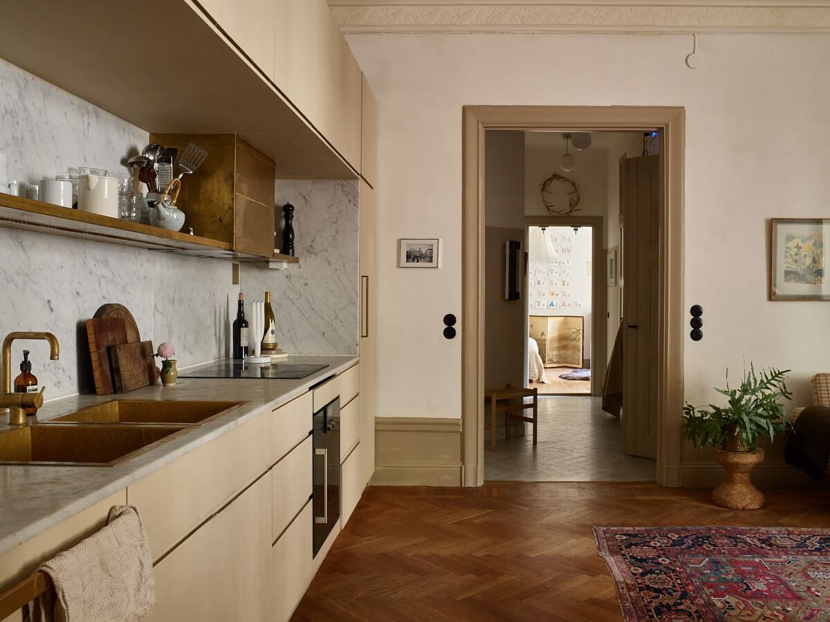 A Beige Vintage Apartment in Stockholm 11 kitchen-beige-cabinets-shelf-closed-cabinets-wooden-herringbone-floor-nordroom