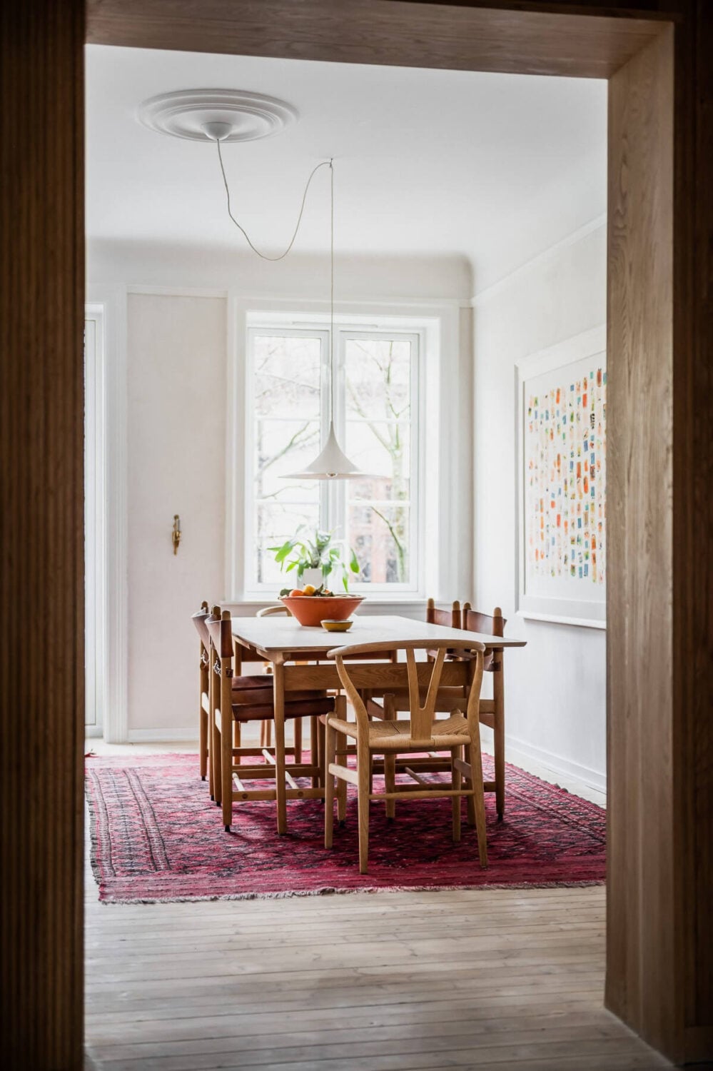 An Oslo Apartment with Custom Made Storage Solutions 9 kitchen-dining-space-pink-rug-wooden-floor-nordroom