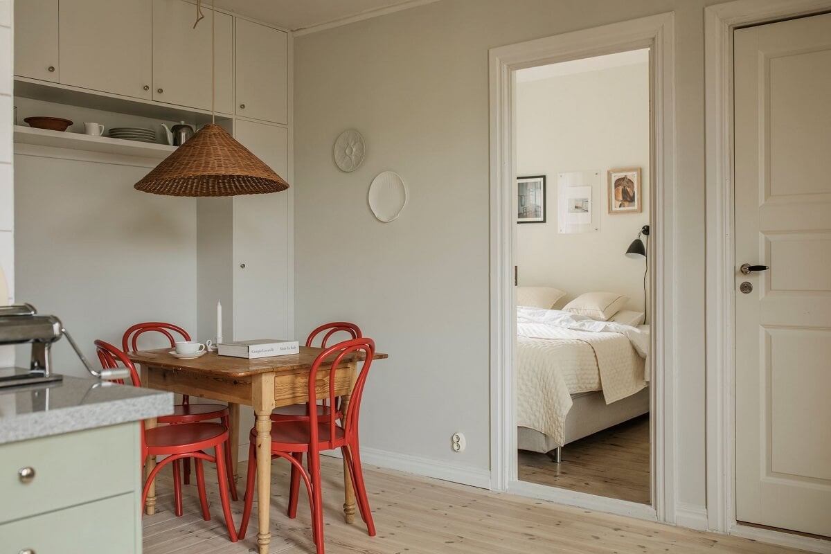 A Serene Light Colored Apartment in Stockholm 7 kitchen-dining-table-red-chairs-nordroom
