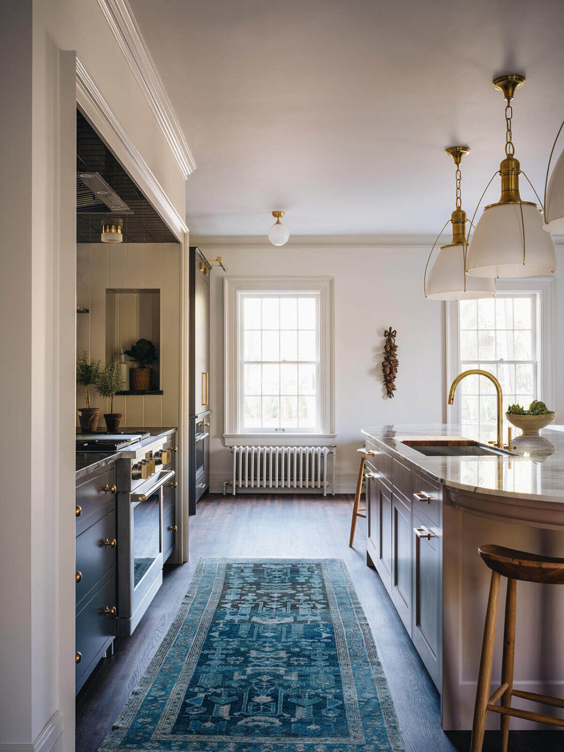 A Classic 1930s Home in Grand Rapids Designed by Jean Stoffer 9 kitchen-jean-stoffer-interior-design-blue-runner-rounded-island-nordroom