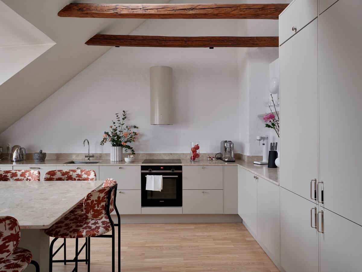 Pastel Color Accents in a Scandinavian Penthouse Apartment 9 kitchen-wooden-beams-light-gray-cabinets-nordroom