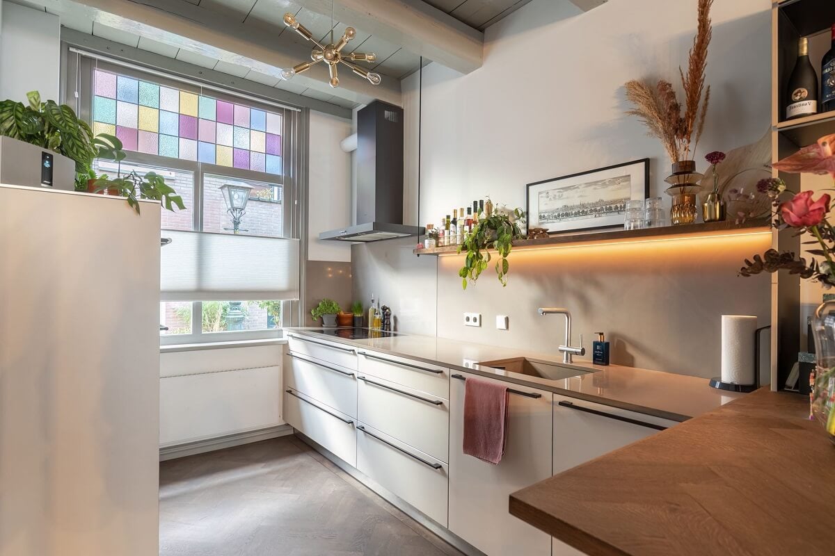 Gray and Earth Tones in a Restored Weavers House in The Netherlands 7 l-shaped-kitchen-white-cabinets-gray-ceiling-nordroom