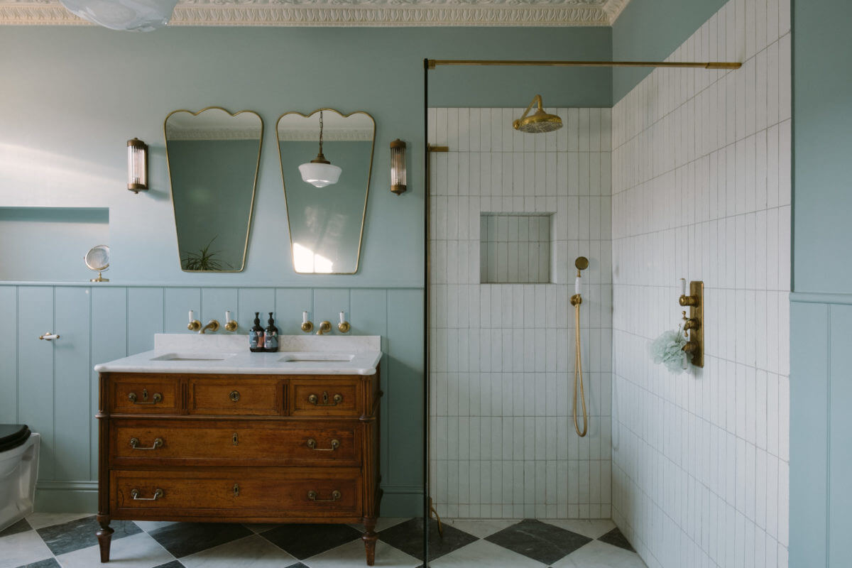 Best of 2023: Bathrooms 23 light-blue-bathroom-antique-vanity-walk-in-shower-checkerboard-floor-nordroom
