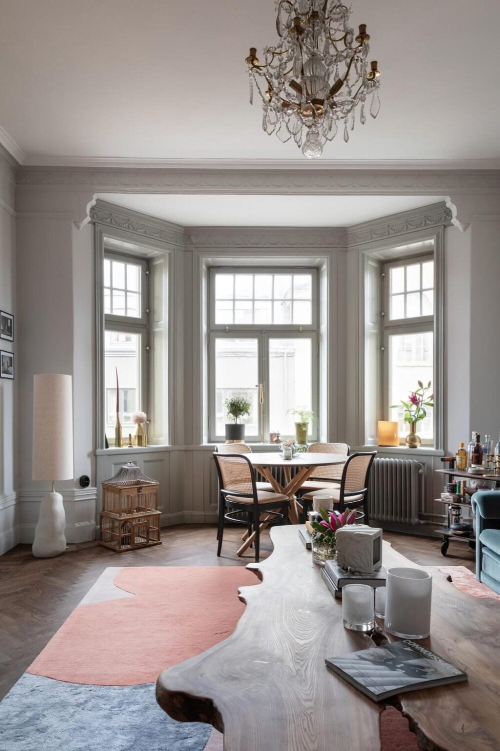 A Classic Swedish Apartment with Light Gray Walls 2 living-room-bay-window-parquet-floor-large-pastel-rug-nordroom