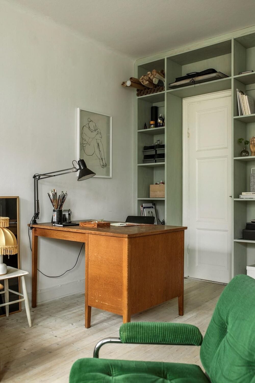 A Small Swedish Apartment Decorated in Midcentury Style 4 living-room-bespoke-green-bookcase-vintage-desk-nordroom