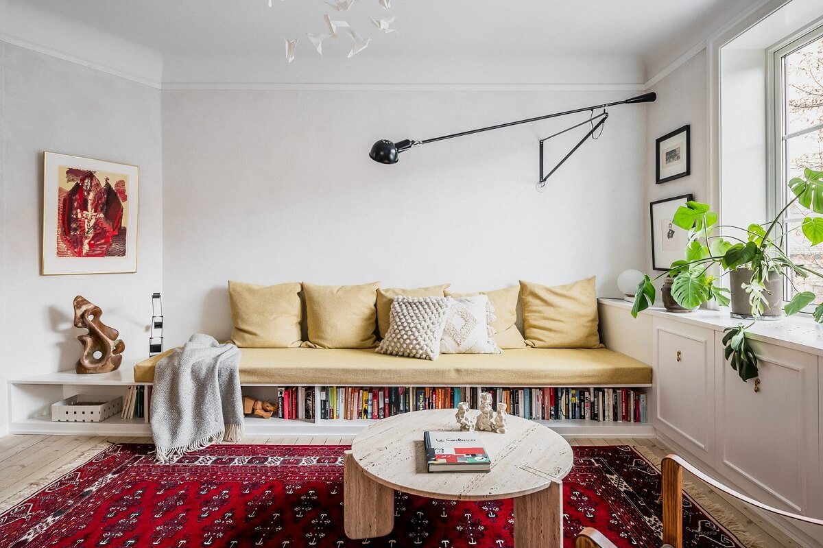 An Oslo Apartment with Custom Made Storage Solutions 4 living-room-built-in-sofa-storage-pink-rug-nordroom