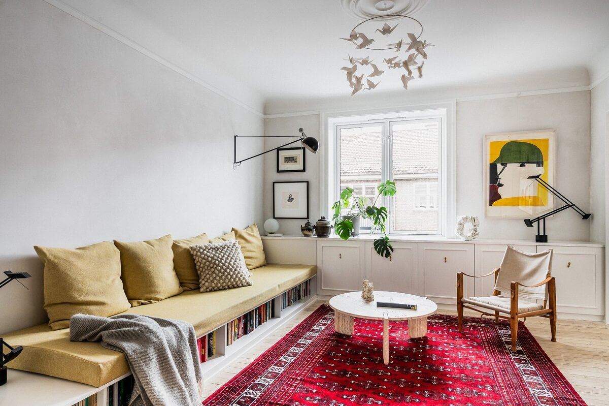 An Oslo Apartment with Custom Made Storage Solutions 2 living-room-custom-made-sofa-storage-pink-rug-nordroom