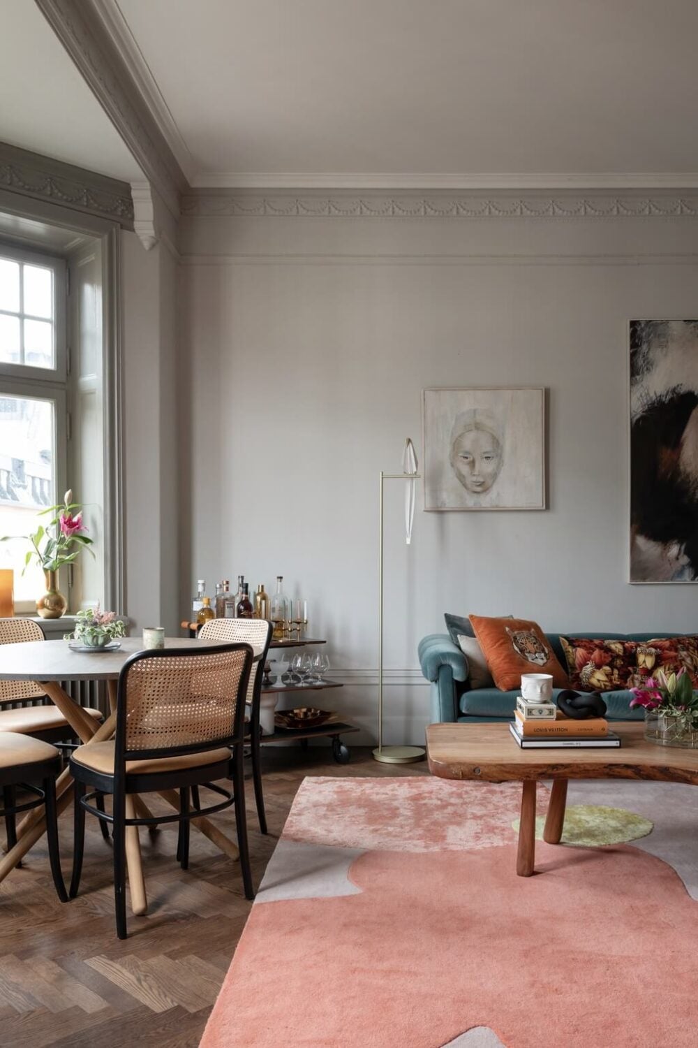 A Classic Swedish Apartment with Light Gray Walls 3 living-room-round-dining-table-parquet-floor-pastel-rug-nordroom