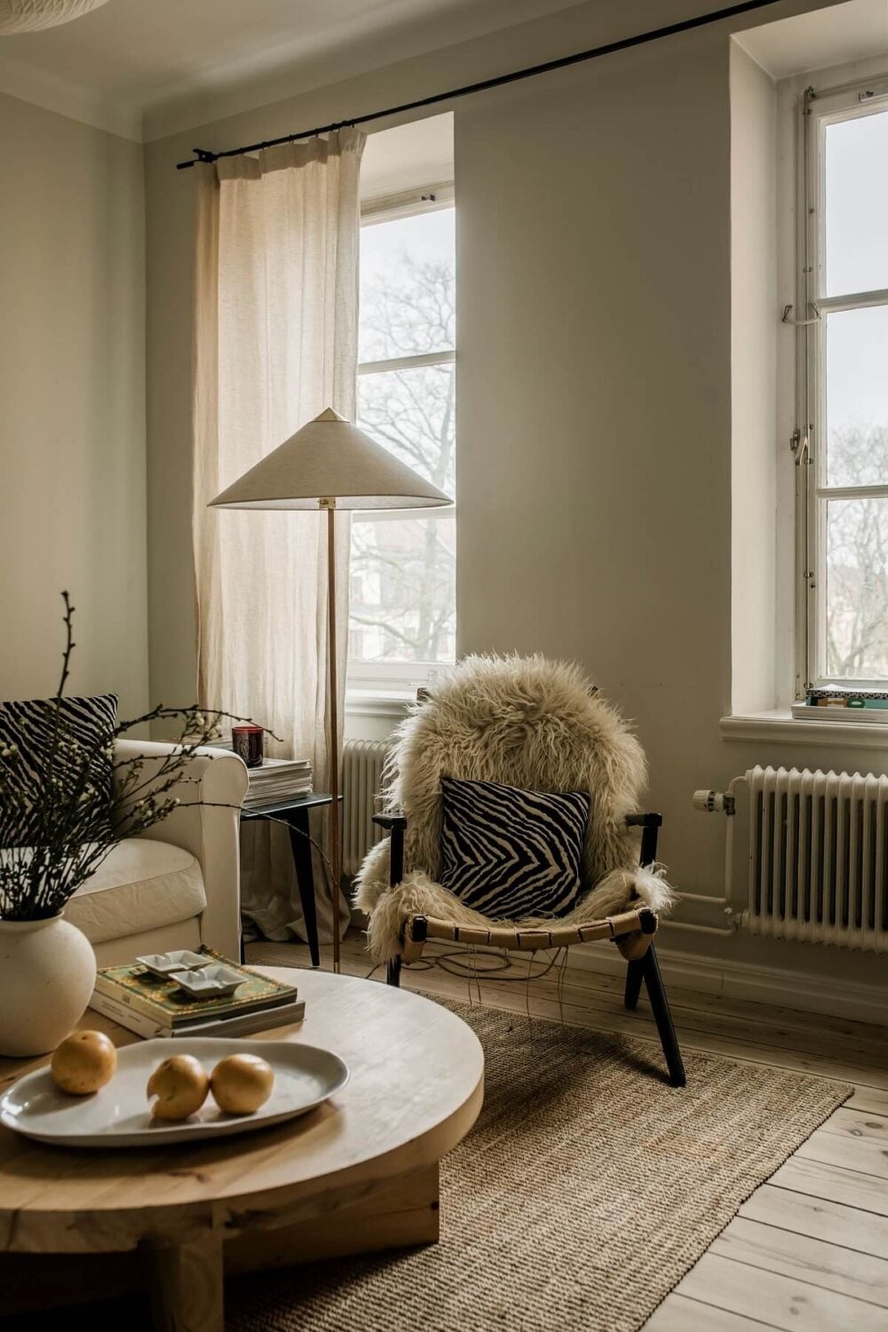 A Serene Light Colored Apartment in Stockholm 3 living-room-wooden-floor-jute-rug-light-colors-nordroom