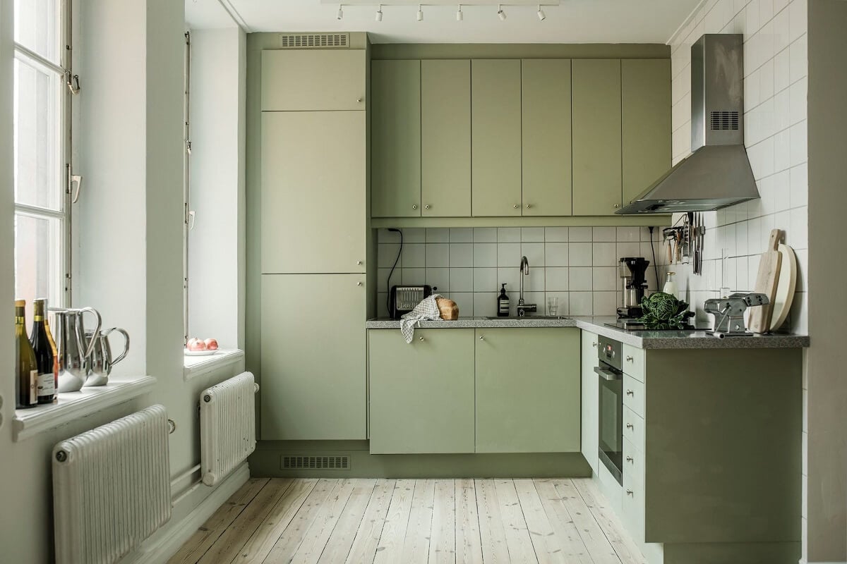A Serene Light Colored Apartment in Stockholm 5 mint-green-kitchen-wooden-floor-serene-scandinavian-home-nordroom