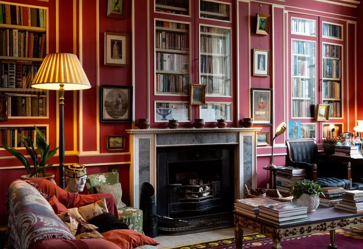 A Historic Greek Revival Country House in Scotland is For Sale 2 red-library-sitting-room-art-books-fireplace-nordroom