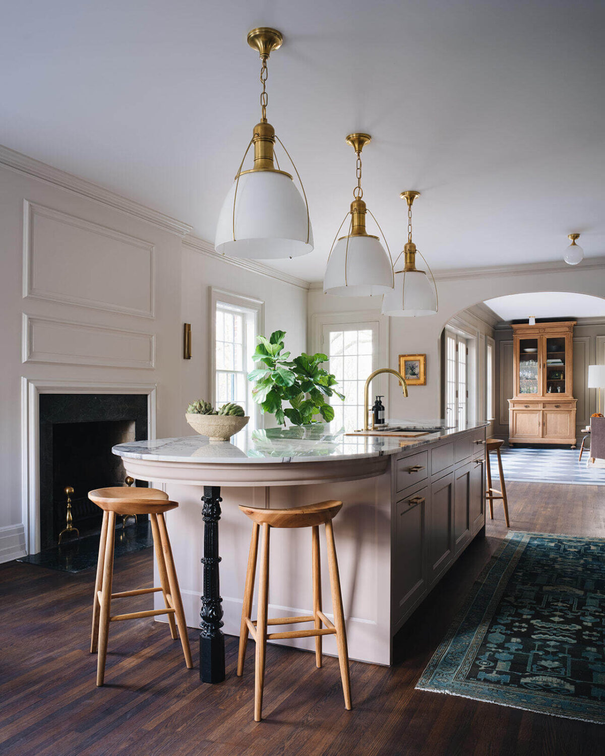 A Classic 1930s Home in Grand Rapids Designed by Jean Stoffer 14 rounded-kitchen-island-breakfast-bar-fireplace-runner-nordroom