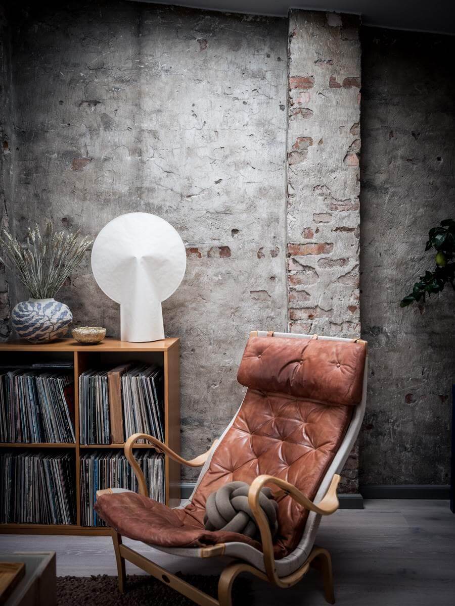 A Small Scandinavian Loft with Skylights and Brick Wall 3 scandinavian-lounge-chair-exposed-brick-wall-nordroom