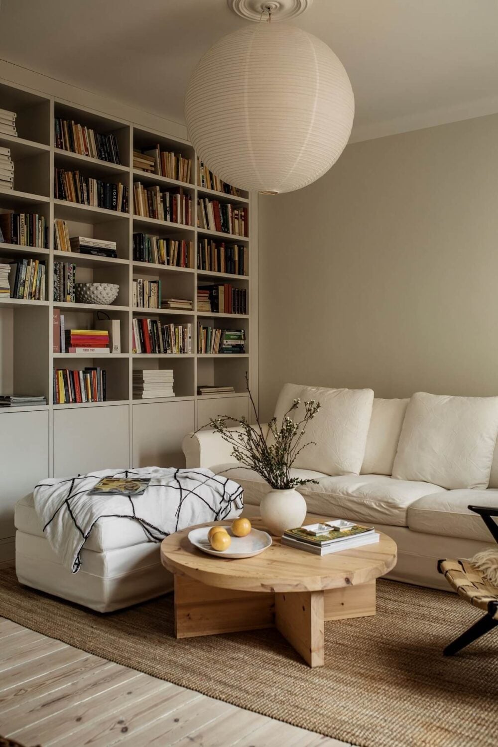 A Serene Light Colored Apartment in Stockholm 1 serene-living-room-built-in-bookcase-white-sofa-wooden-floor-nordroom