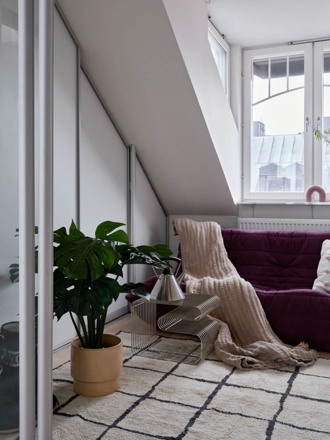 Pastel Color Accents in a Scandinavian Penthouse Apartment 10 sitting-room-purple-togo-sofa-nordroom