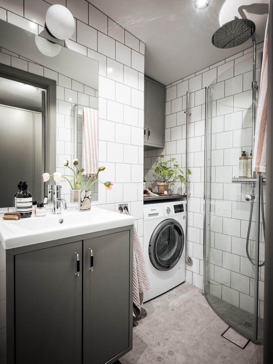 A Small Scandinavian Loft with Skylights and Brick Wall 14 small-bathroom-with-niche-for-washing-machine-gray-white-tiles