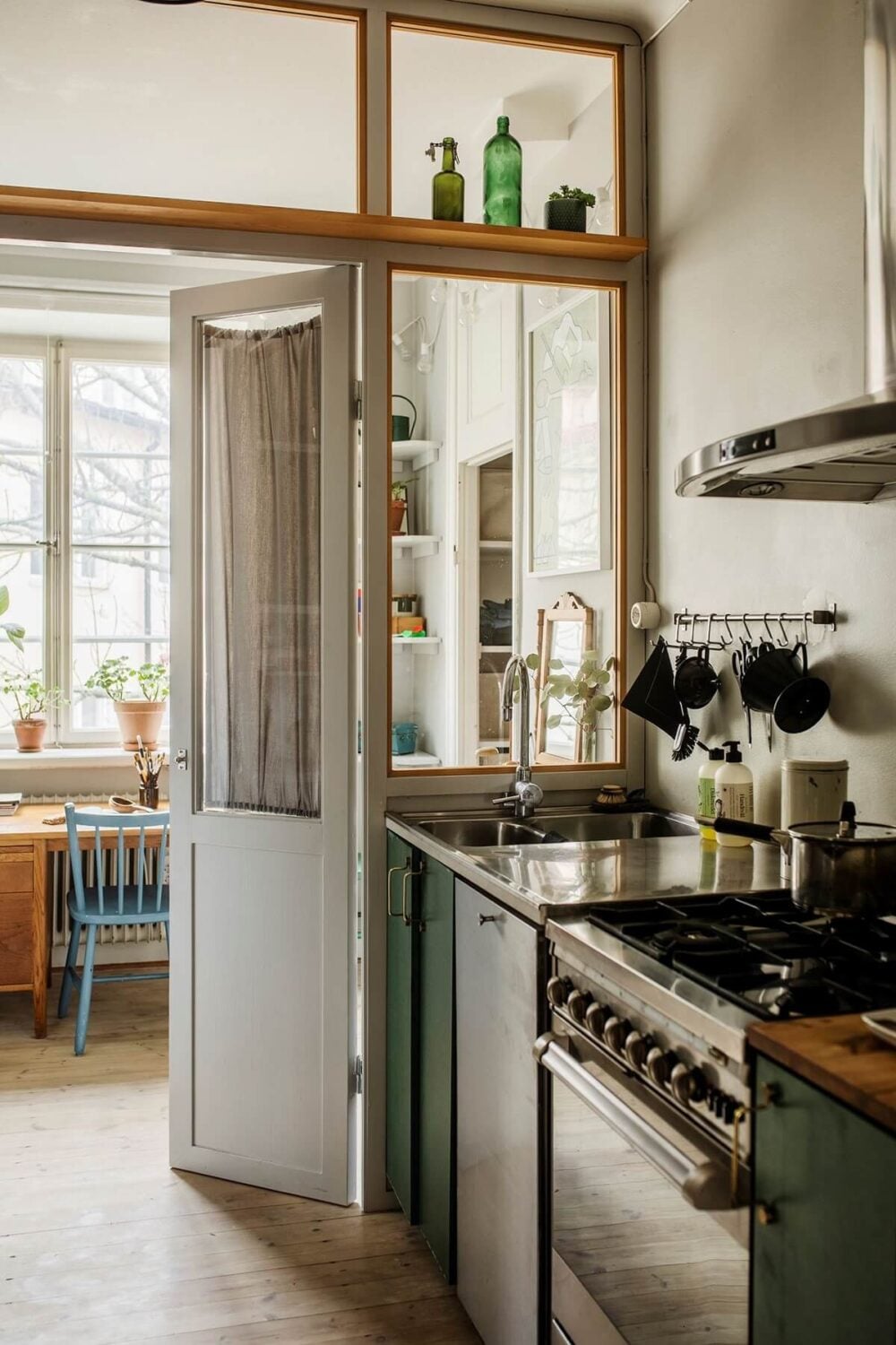 A Small Swedish Apartment Decorated in Midcentury Style 10 small-kitchen-green-cabinets-bedroom-nordroom
