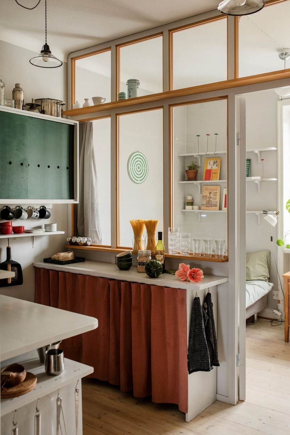 Small Space, Big Style: How to Design a Teeny-Tiny Kitchen That Works 23 small-kitchen-green-cabinets-window-between-bedroom-nordroom