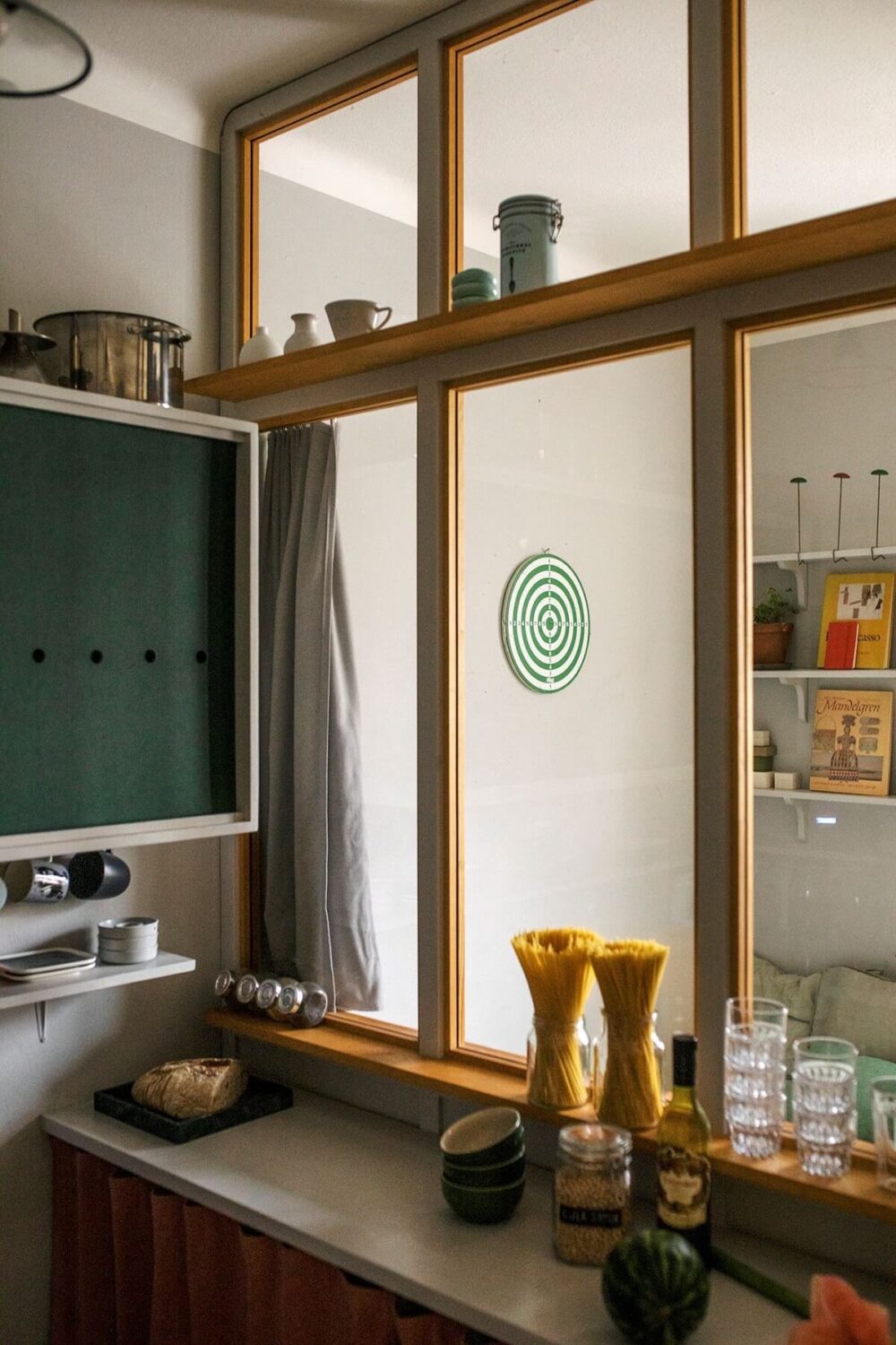 A Small Swedish Apartment Decorated in Midcentury Style 11 small-kitchen-midcentury-style-green-cabinets-nordroom