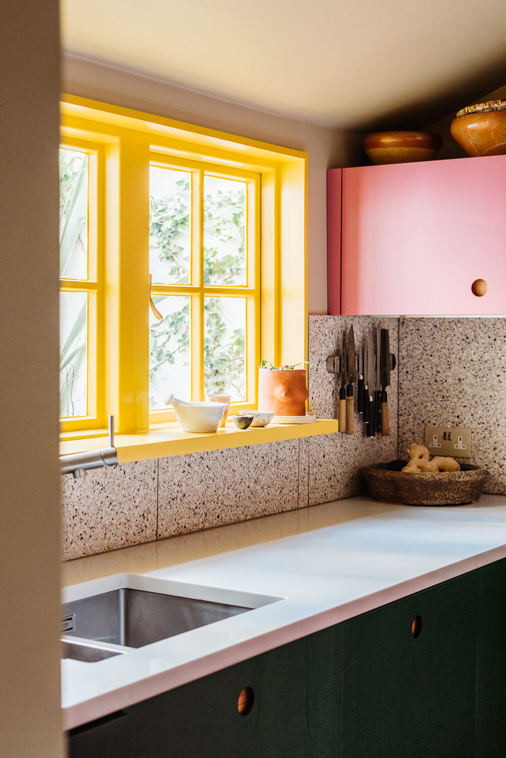 Small Space, Big Style: How to Design a Teeny-Tiny Kitchen That Works 27 small-kitchen-pink-green-cabinets-yellow-window-nordroom