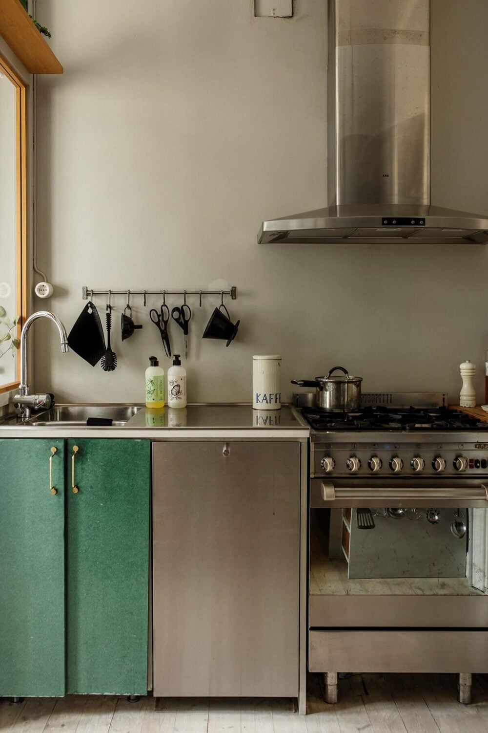 A Small Swedish Apartment Decorated in Midcentury Style 9 small-kitchen-stainless-steel-green-cabinets-nordroom